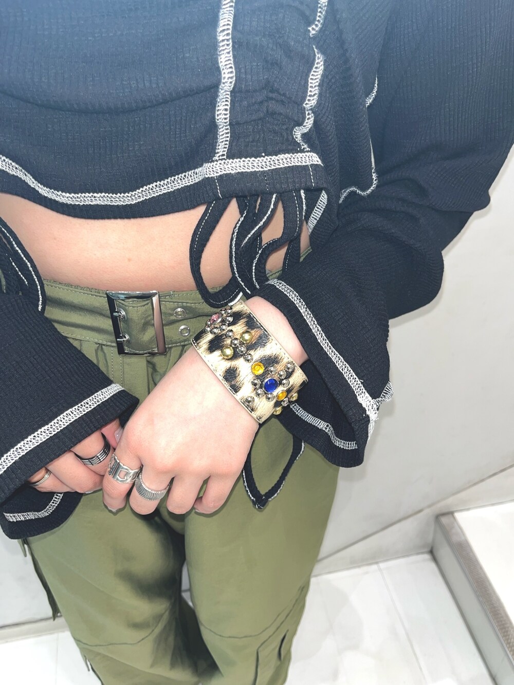 グリーン系のその他パンツ、ブラック系のTシャツ/カットソー、シルバー系のネックレスを着用したレディースの春コーディネートの6枚目の写真