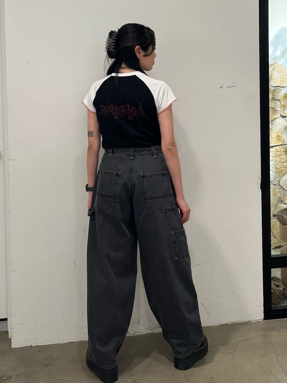 ブラック系のTシャツ/カットソー、ブラック系のデニムパンツを着用したレディースの春コーディネートの3枚目の写真