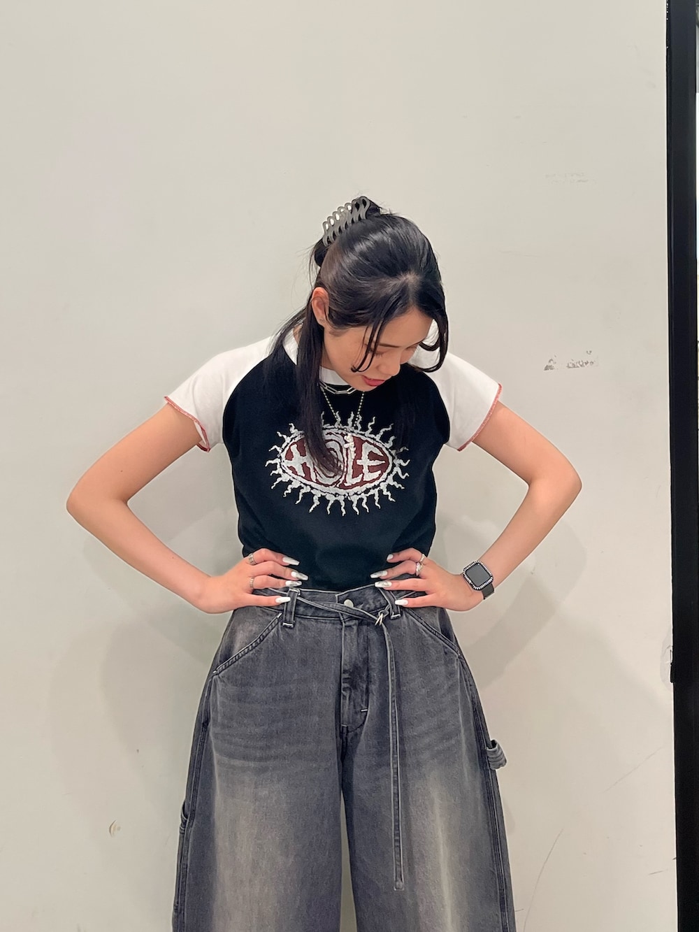 ブラック系のTシャツ/カットソー、ブラック系のデニムパンツを着用したレディースの春コーディネートの4枚目の写真