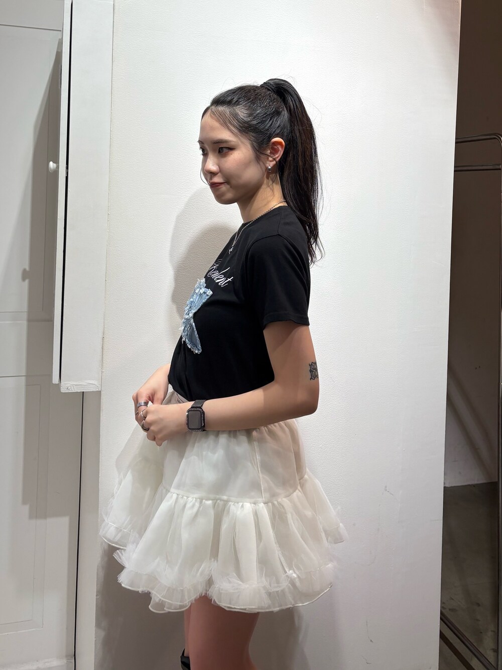 ブラック系のTシャツ/カットソー、ホワイト系のスカートを着用したレディースの春コーディネートの4枚目の写真