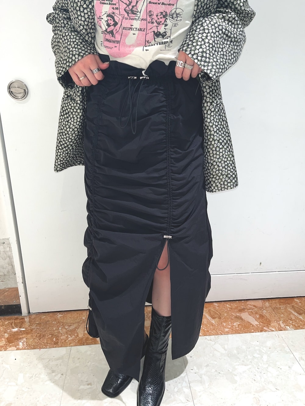 ブラック系のスカート、ブラック系のテーラードジャケット、ホワイト系のTシャツ/カットソーを着用したレディースの春コーディネートの7枚目の写真