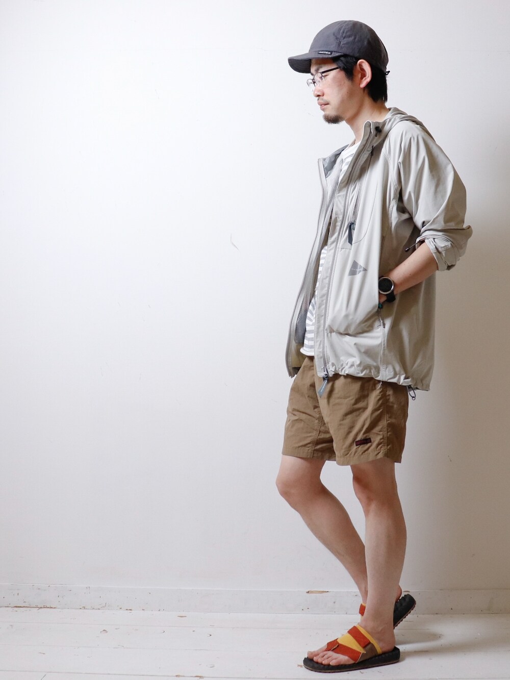 グレー系のTシャツ/カットソー、ホワイト系のマウンテンパーカー、ベージュ系のその他パンツを着用したメンズの春コーディネートの2枚目の写真