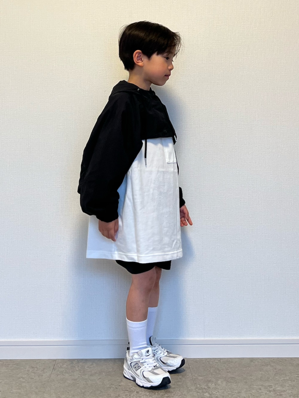 ホワイト系のスニーカー、ブラック系のカーゴパンツ、ホワイト系のTシャツ/カットソーを着用したキッズの春コーディネートの3枚目の写真