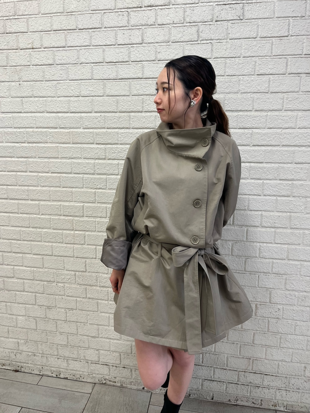 ベージュ系のその他パンツ、グリーン系のトレンチコートを着用したレディースの春コーディネートの4枚目の写真