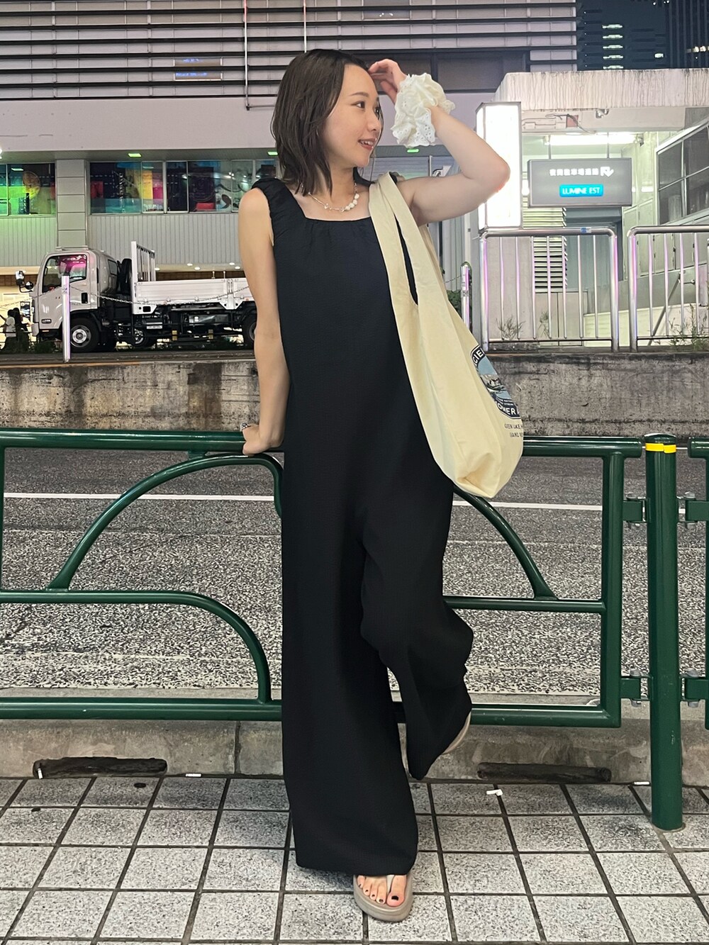 ブラック系のつなぎ/オールインワン、ホワイト系のトートバッグ、シルバー系のネックレスを着用したレディースの夏コーディネートの2枚目の写真