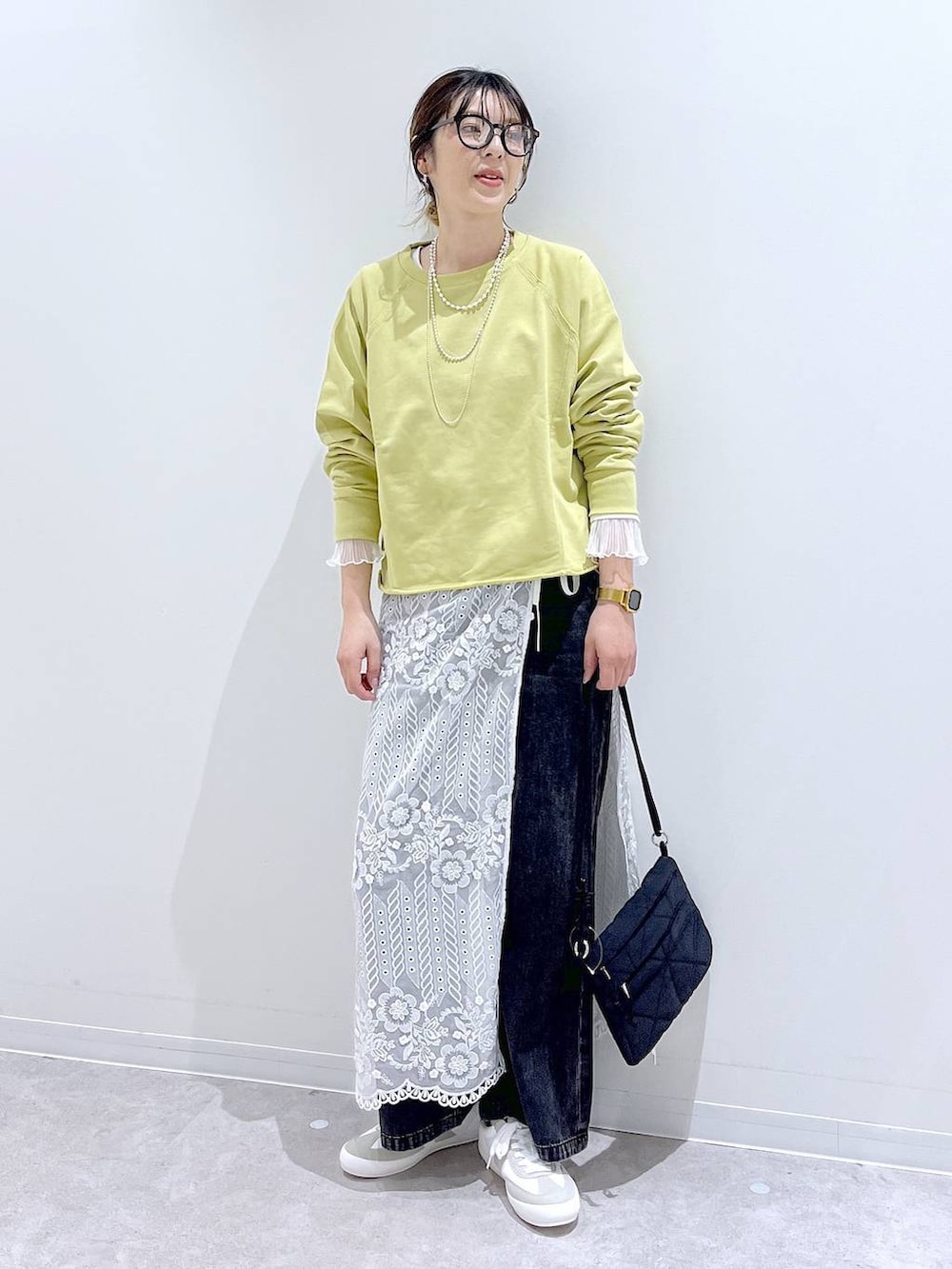 ホワイト系のスニーカー、ブラック系のデニムパンツ、ホワイト系のTシャツ/カットソーを着用したレディースの秋コーディネートの4枚目の写真