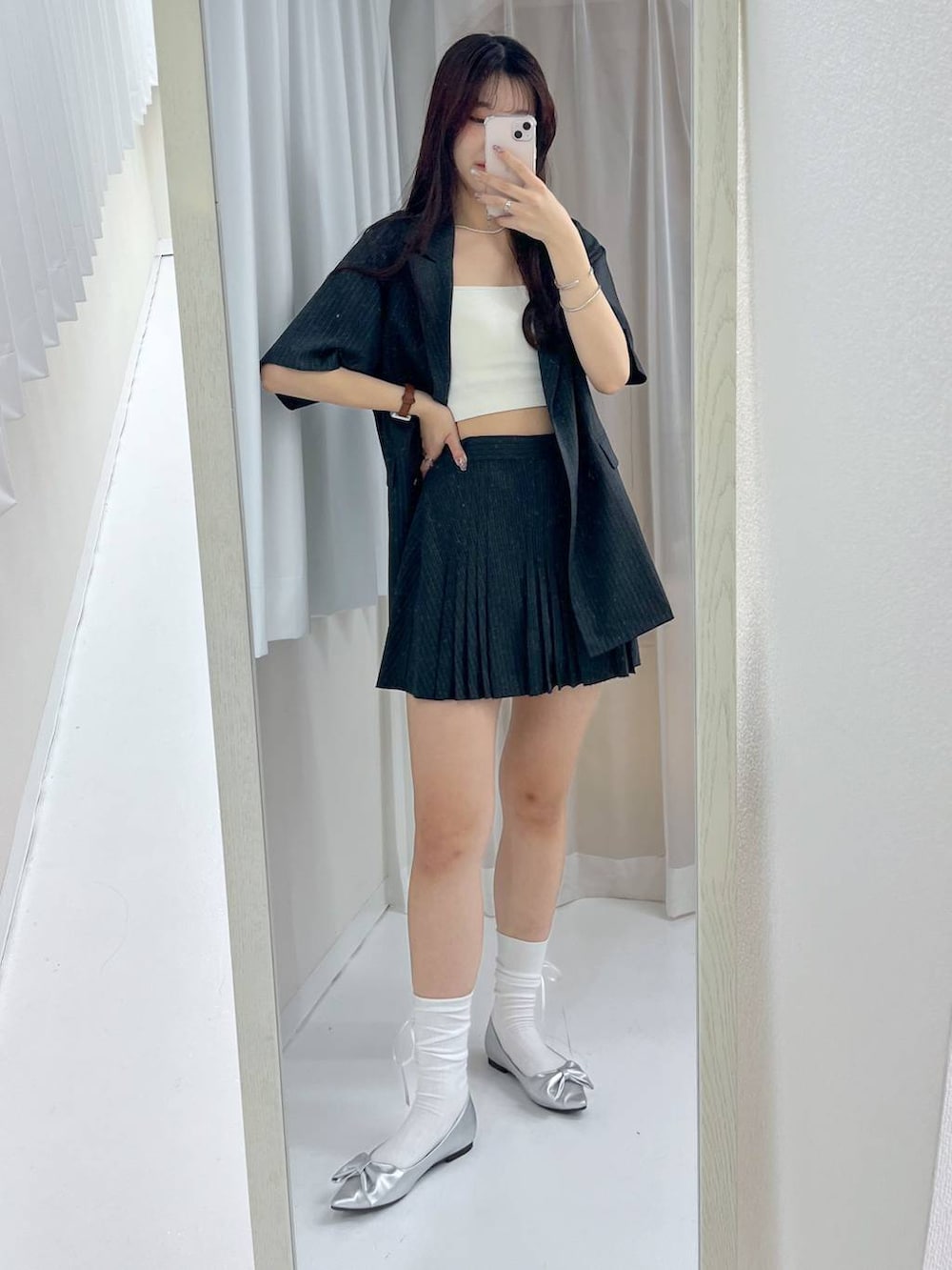 グレー系のスカート、ホワイト系のキャミソール、シルバー系のパンプスを着用したレディースの春コーディネートの2枚目の写真