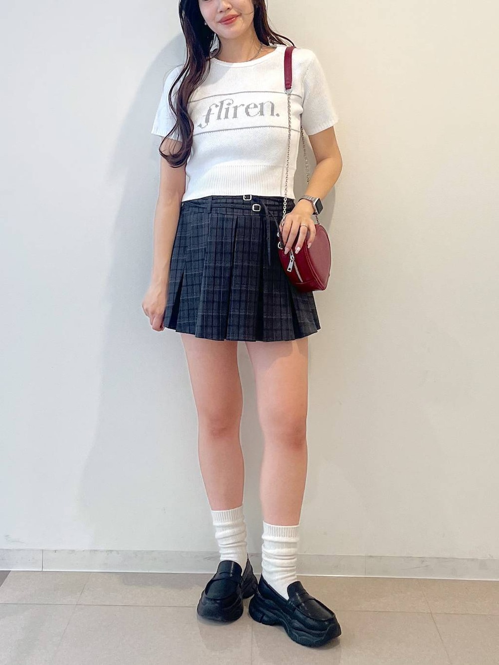 ホワイト系のキャミソール、ブラック系のローファー、グレー系のスカートを着用したレディースの夏コーディネートの6枚目の写真