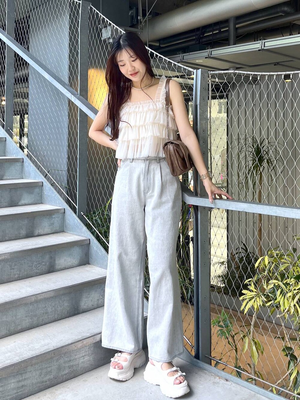 ブラウン系のショルダーバッグ、ホワイト系のキャミソール、ホワイト系のキャミソールを着用したレディースの夏コーディネートの3枚目の写真