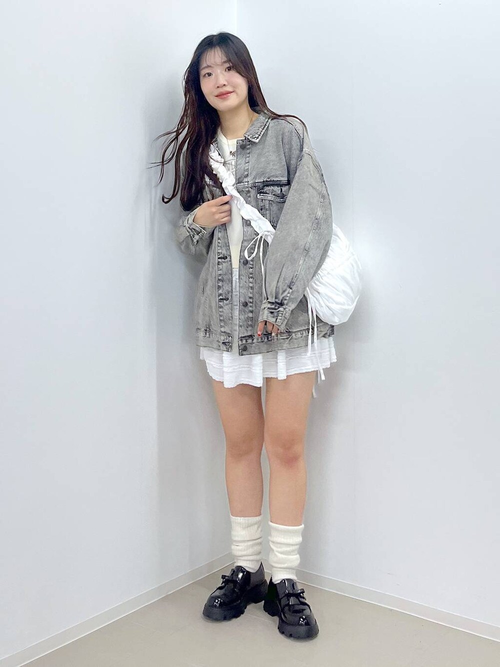 ホワイト系のTシャツ/カットソー、ブラック系のドレスシューズ、ホワイト系のニット/セーターを着用したレディースの冬コーディネートの6枚目の写真