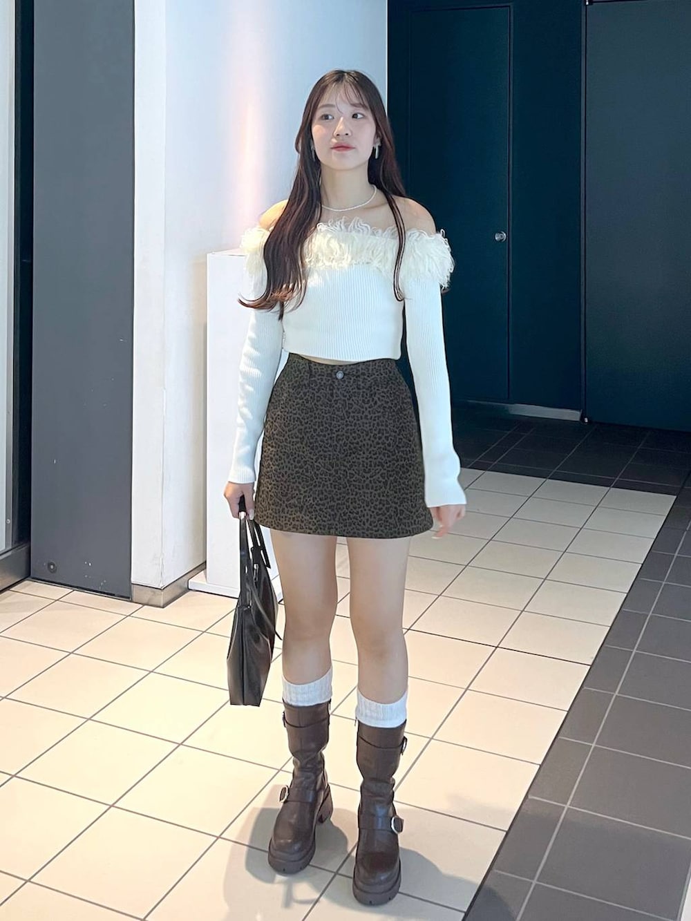 ブラウン系のブーツ、その他のスカート、ホワイト系のキャミソールを着用したレディースの秋コーディネートの9枚目の写真