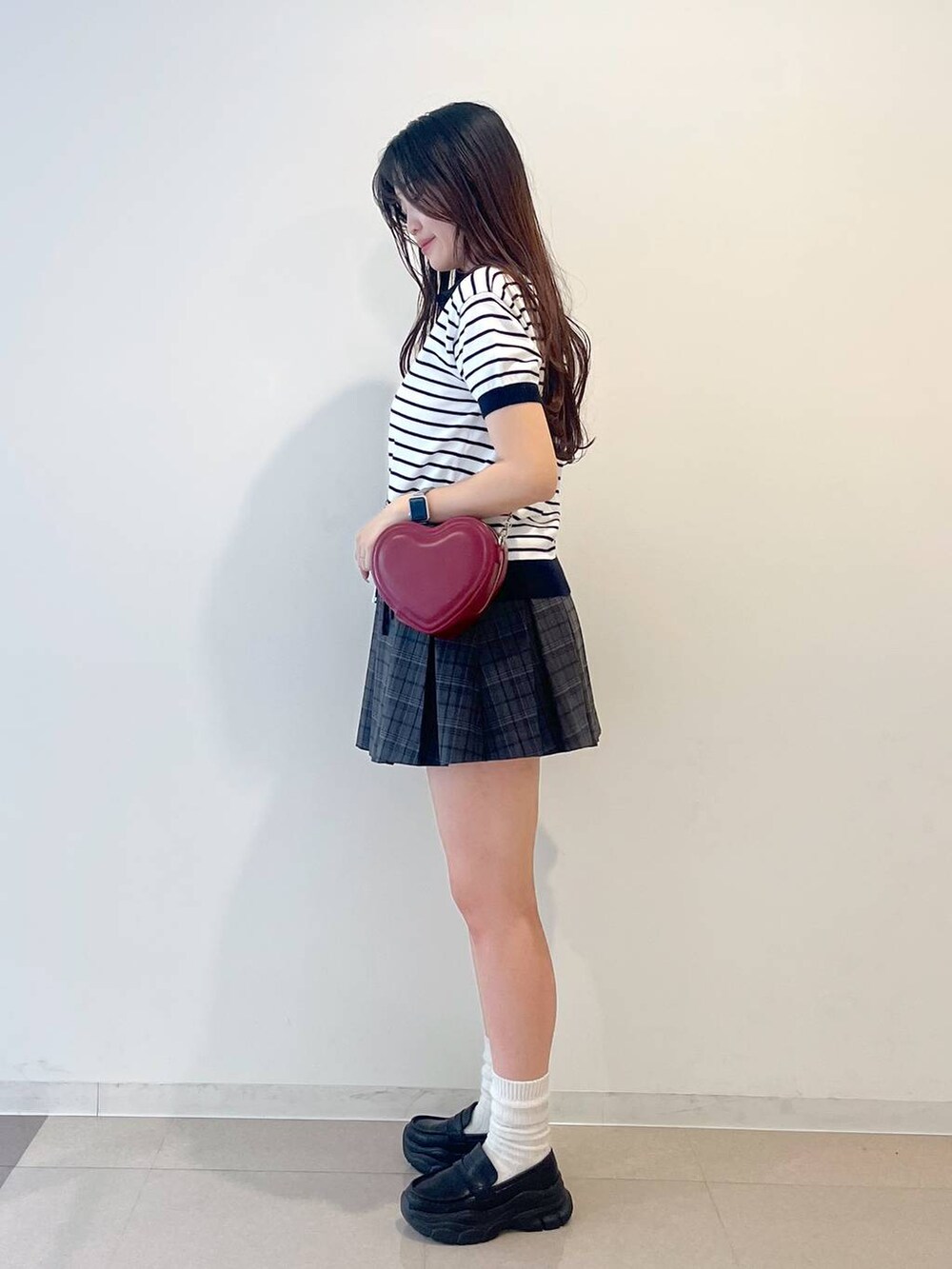 ホワイト系のキャミソール、ブラック系のローファー、グレー系のスカートを着用したレディースの春コーディネートの4枚目の写真