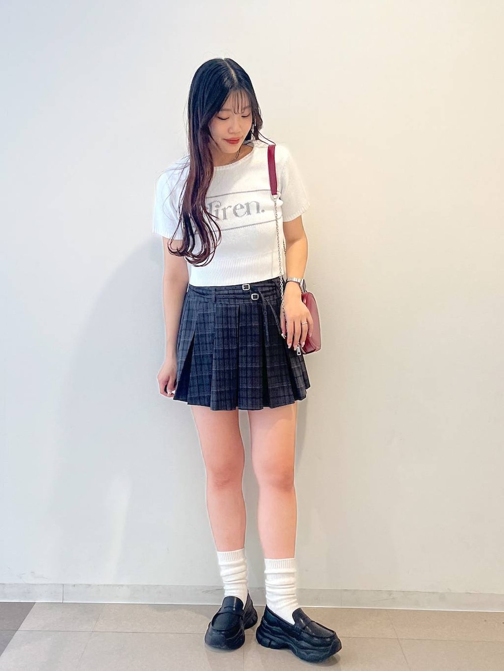 ホワイト系のキャミソール、ブラック系のローファー、グレー系のスカートを着用したレディースの夏コーディネートの2枚目の写真