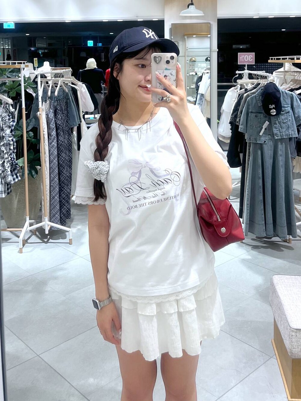 ホワイト系のキャミソール、ホワイト系のスカート、レッド系のボストンバッグを着用したレディースの春コーディネートの7枚目の写真