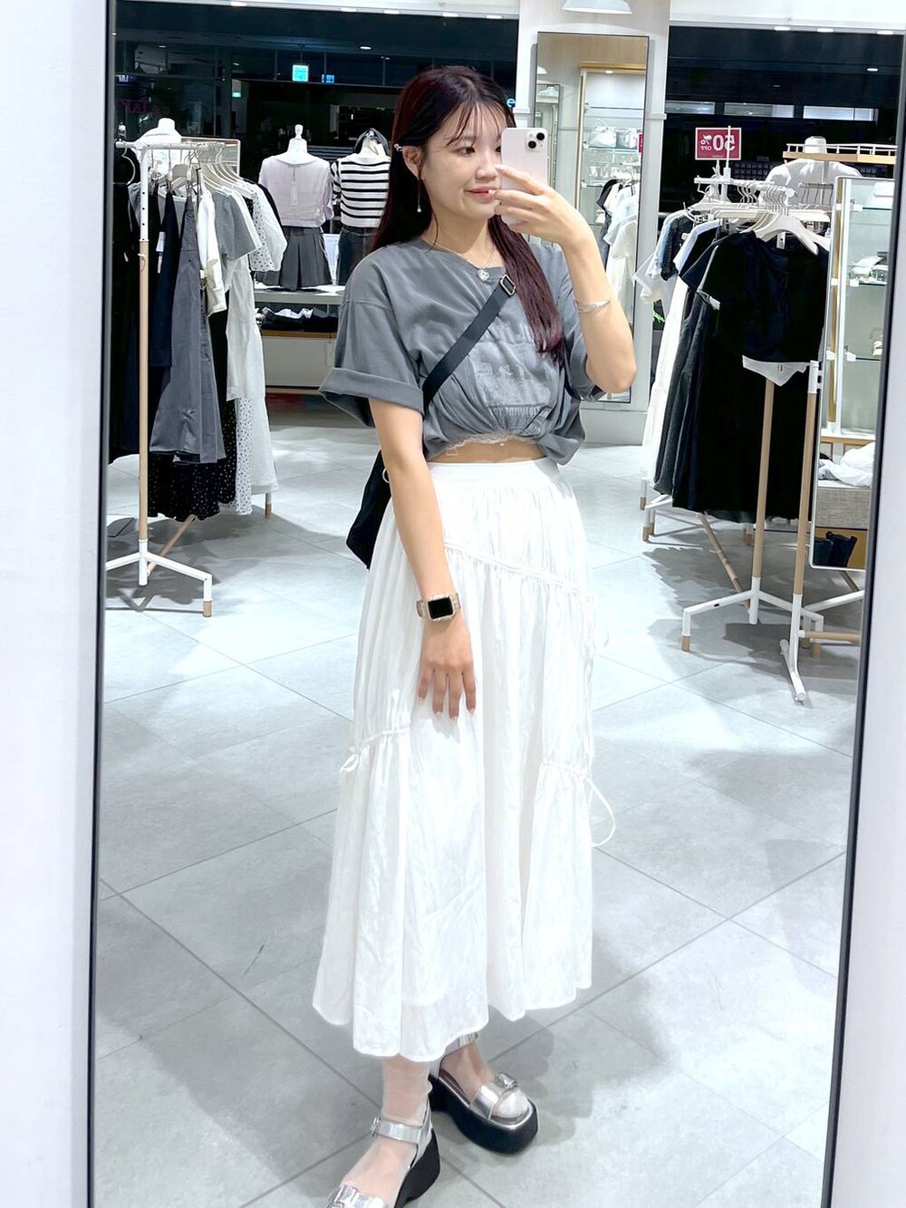 シルバー系のサンダル、ホワイト系のスカート、ホワイト系のキャミソールを着用したレディースの夏コーディネートの3枚目の写真