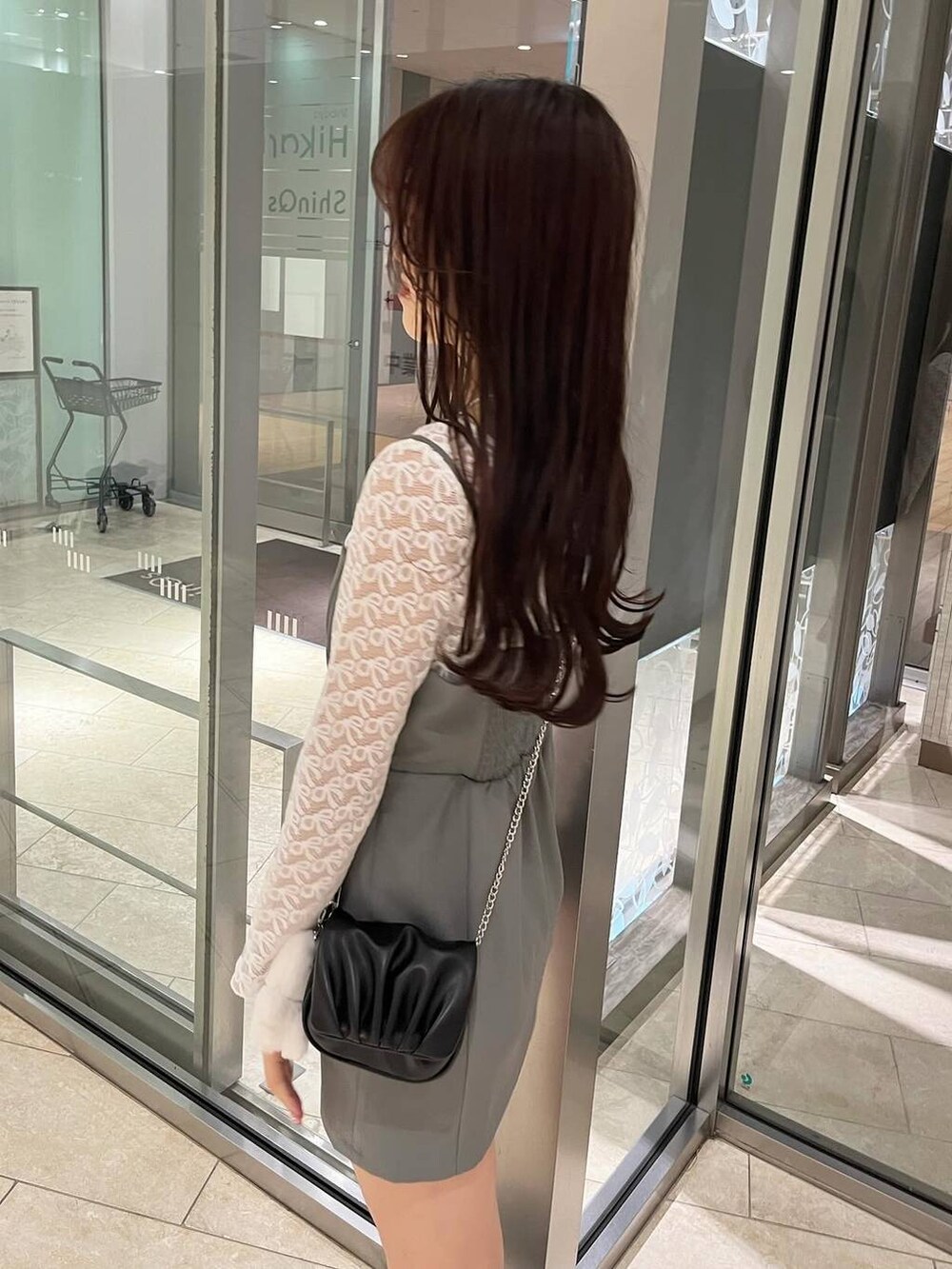 グレー系のワンピース、ホワイト系のキャミソール、ブラック系のローファーを着用したレディースの春コーディネートの2枚目の写真