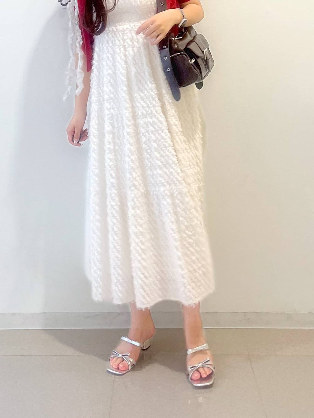 シルバー系のサンダル、ホワイト系のワンピース、レッド系のカーディガン/ボレロを着用したレディースの春コーディネートの7枚目の写真