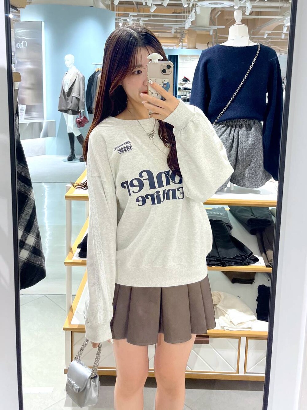 ホワイト系のTシャツ/カットソー、ブラウン系のスカート、ベージュ系のブーツを着用したレディースの秋コーディネートの2枚目の写真