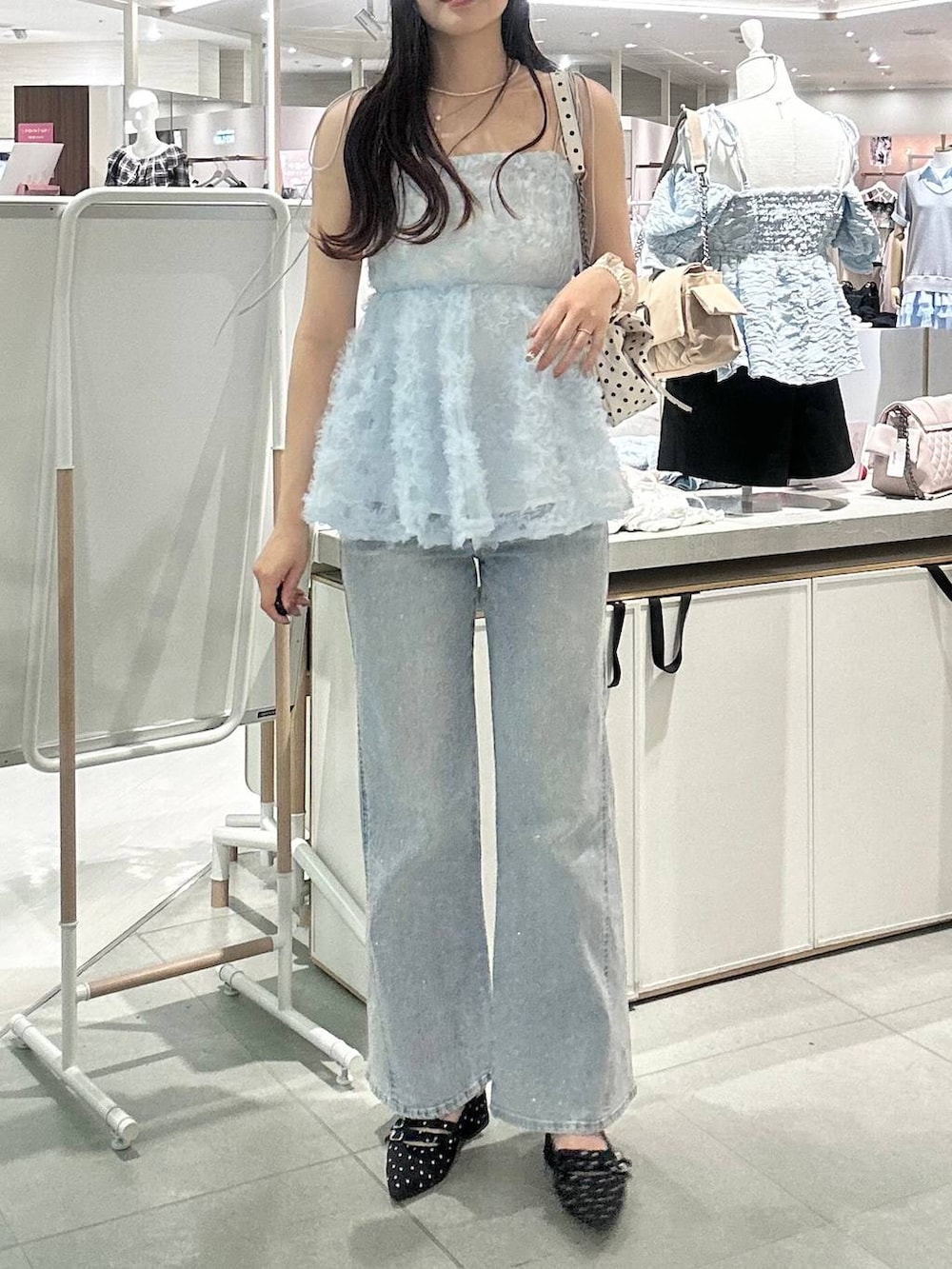 その他のショルダーバッグ、ブラック系のパンプス、ブルー系のキャミソールを着用したレディースの春コーディネートの4枚目の写真