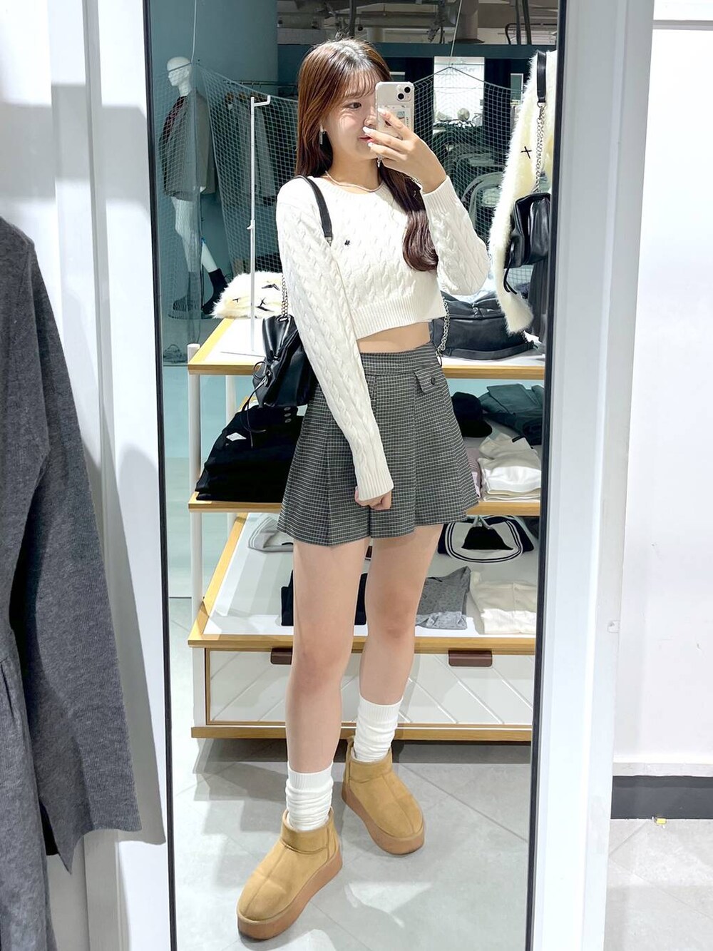 ホワイト系のニット/セーター、ブラック系のショルダーバッグ、ベージュ系のスカートを着用したレディースの秋コーディネートの9枚目の写真