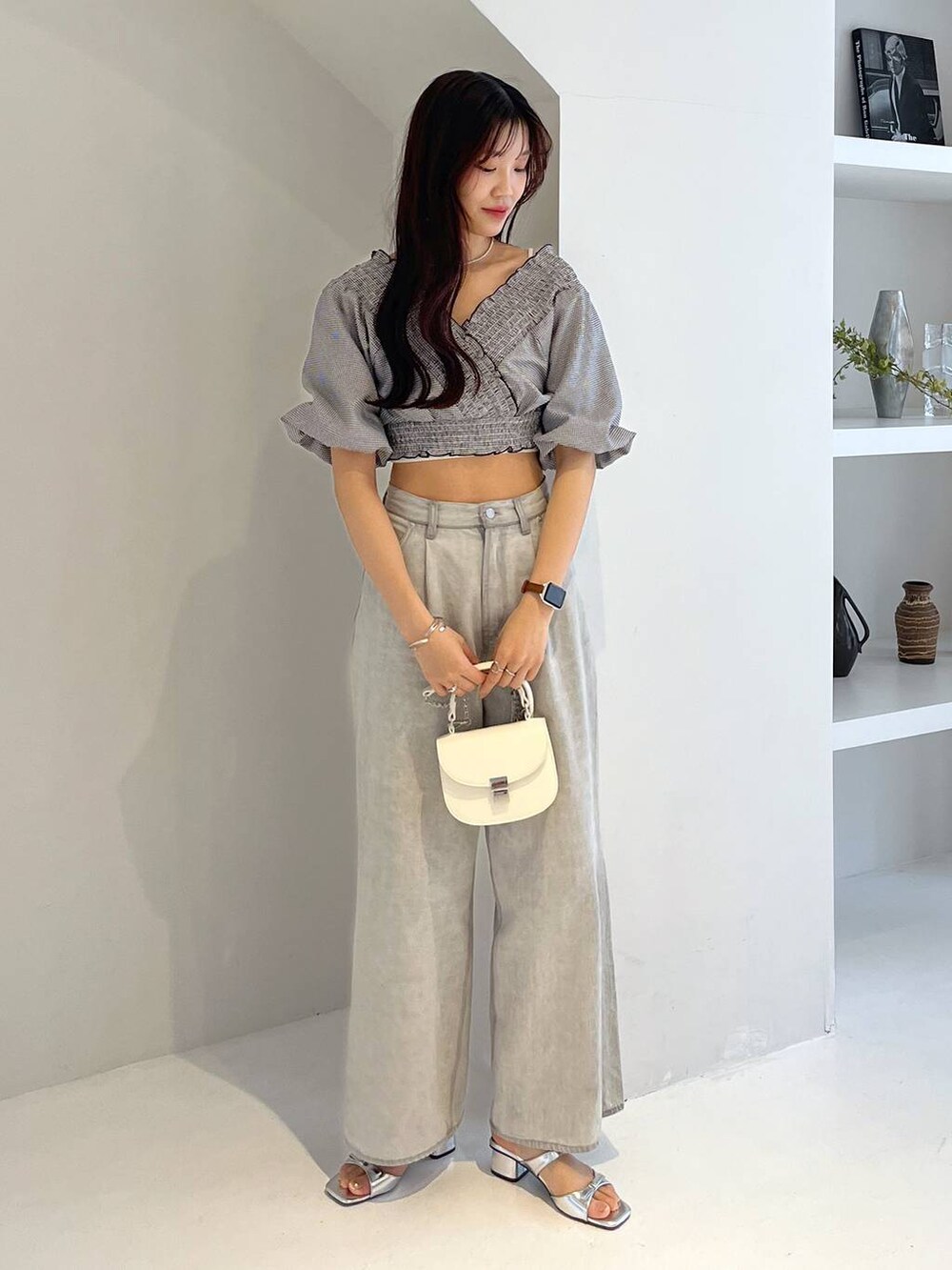 シルバー系のサンダル、ホワイト系のキャミソール、グレー系のデニムパンツを着用したレディースの夏コーディネートの4枚目の写真