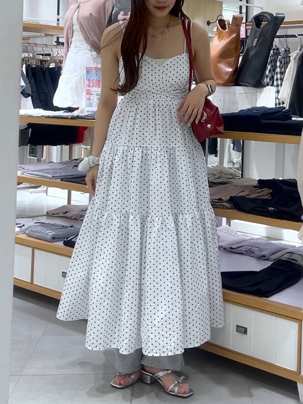 ホワイト系のキャミソール、シルバー系のサンダル、レッド系のボストンバッグを着用したレディースの春コーディネートの4枚目の写真