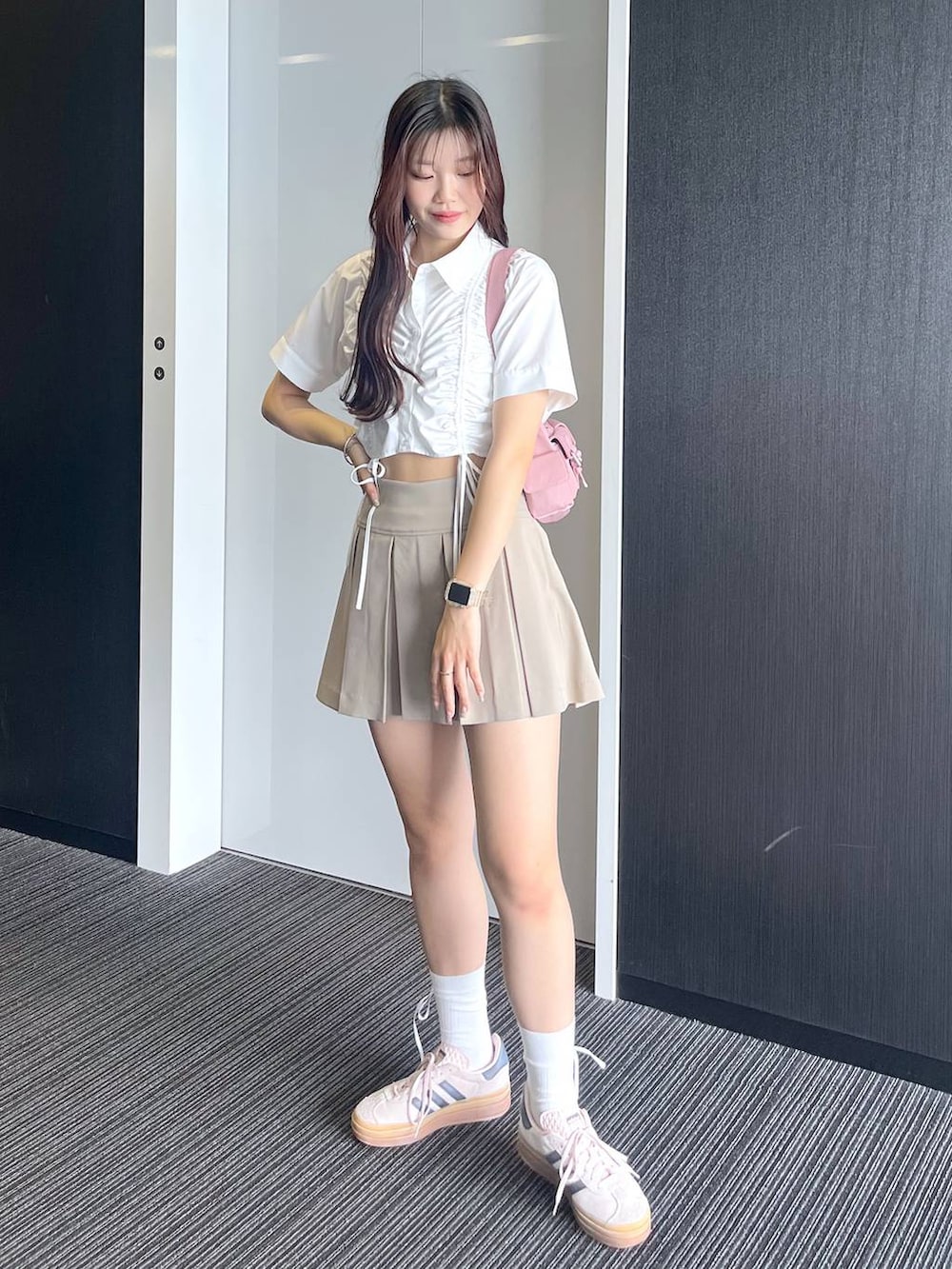 ピンク系のショルダーバッグ、ホワイト系のキャミソール、ベージュ系のスカートを着用したレディースの夏コーディネートの8枚目の写真