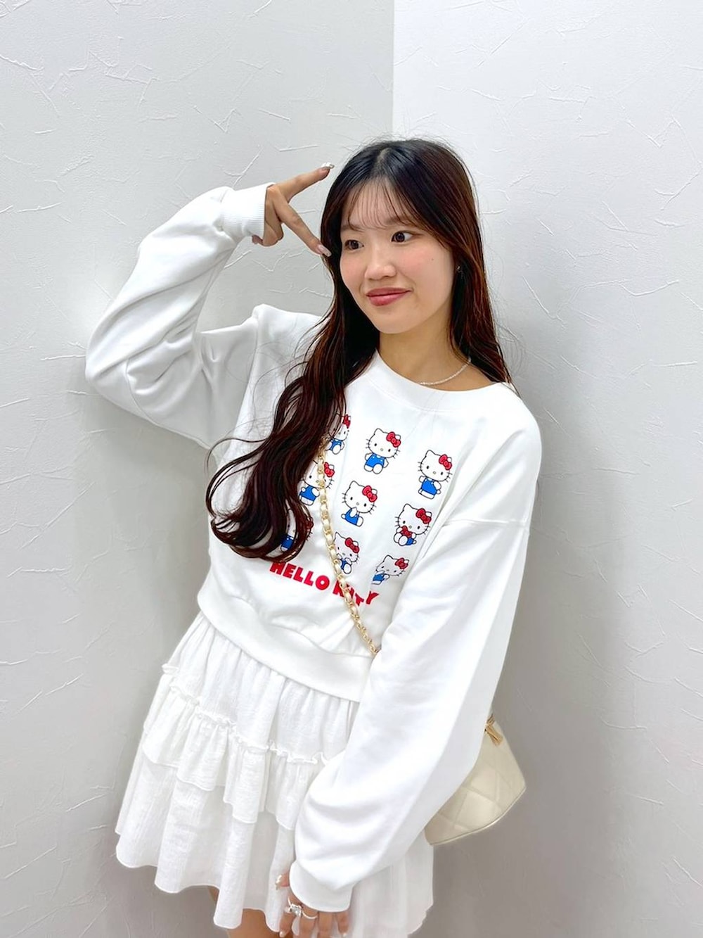 ホワイト系のTシャツ/カットソー、ホワイト系のショルダーバッグ、ホワイト系のブーツを着用したレディースの秋コーディネートの6枚目の写真