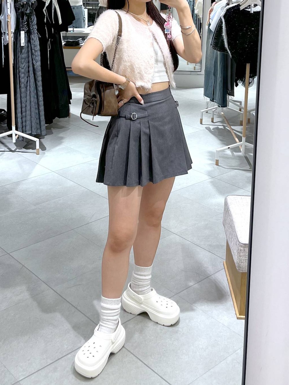 グレー系のスカート、ピンク系のカーディガン/ボレロ、ホワイト系のキャミソールを着用したレディースの夏コーディネートの4枚目の写真