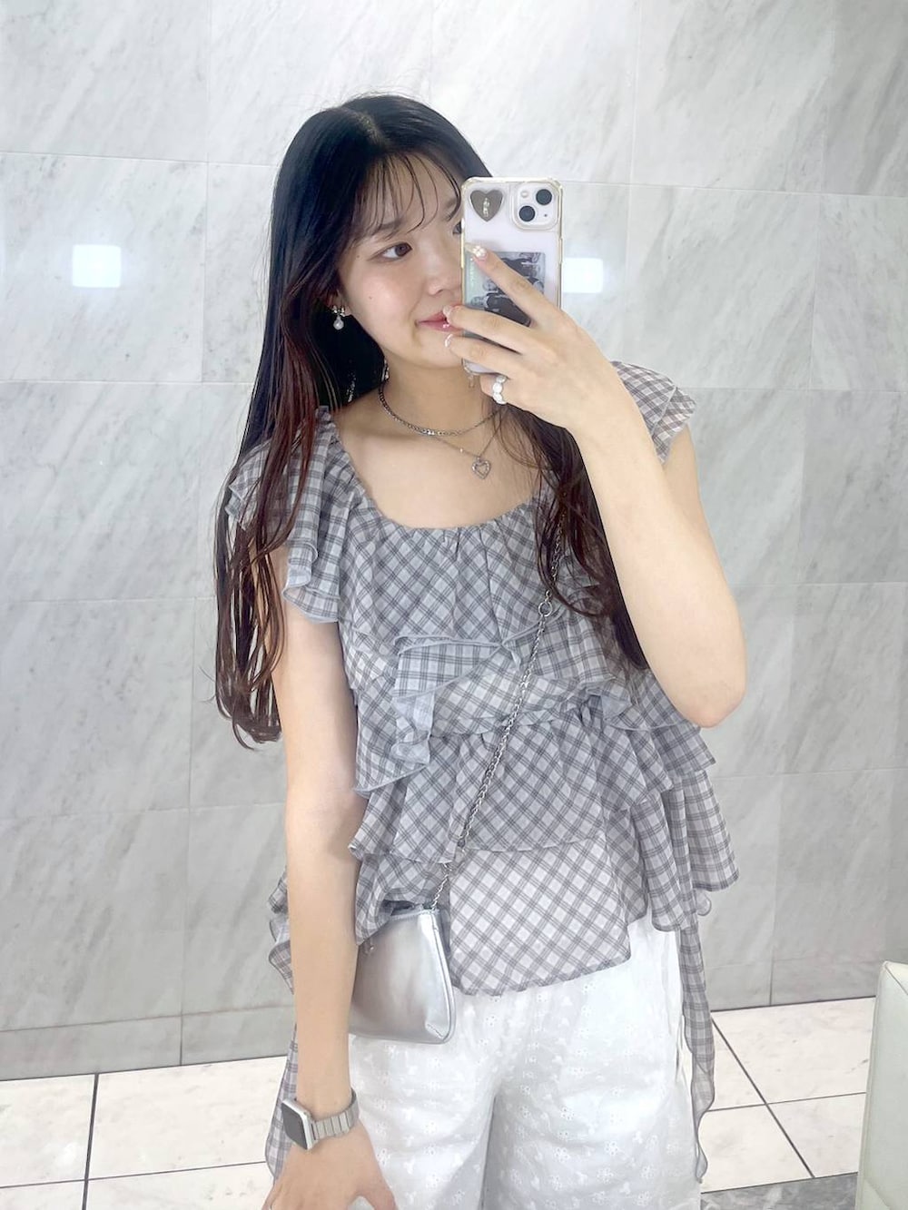 ホワイト系のキャミソール、シルバー系のサンダル、シルバー系のショルダーバッグを着用したレディースの夏コーディネートの2枚目の写真