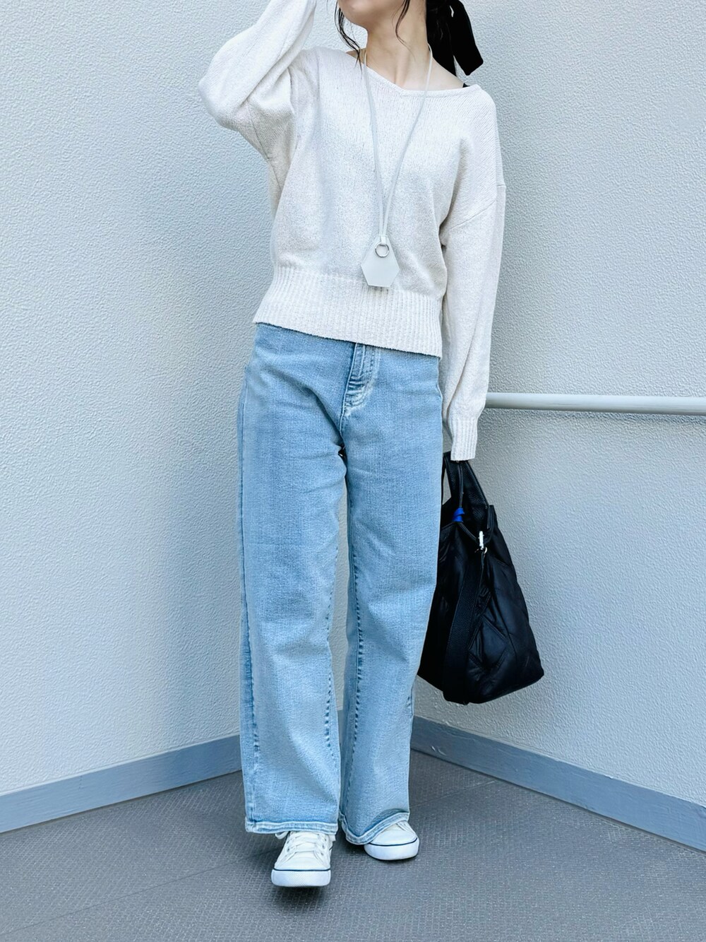 ブラック系のトートバッグ、ホワイト系のニット/セーター、ブルー系のその他パンツを着用したレディースの春コーディネートの2枚目の写真