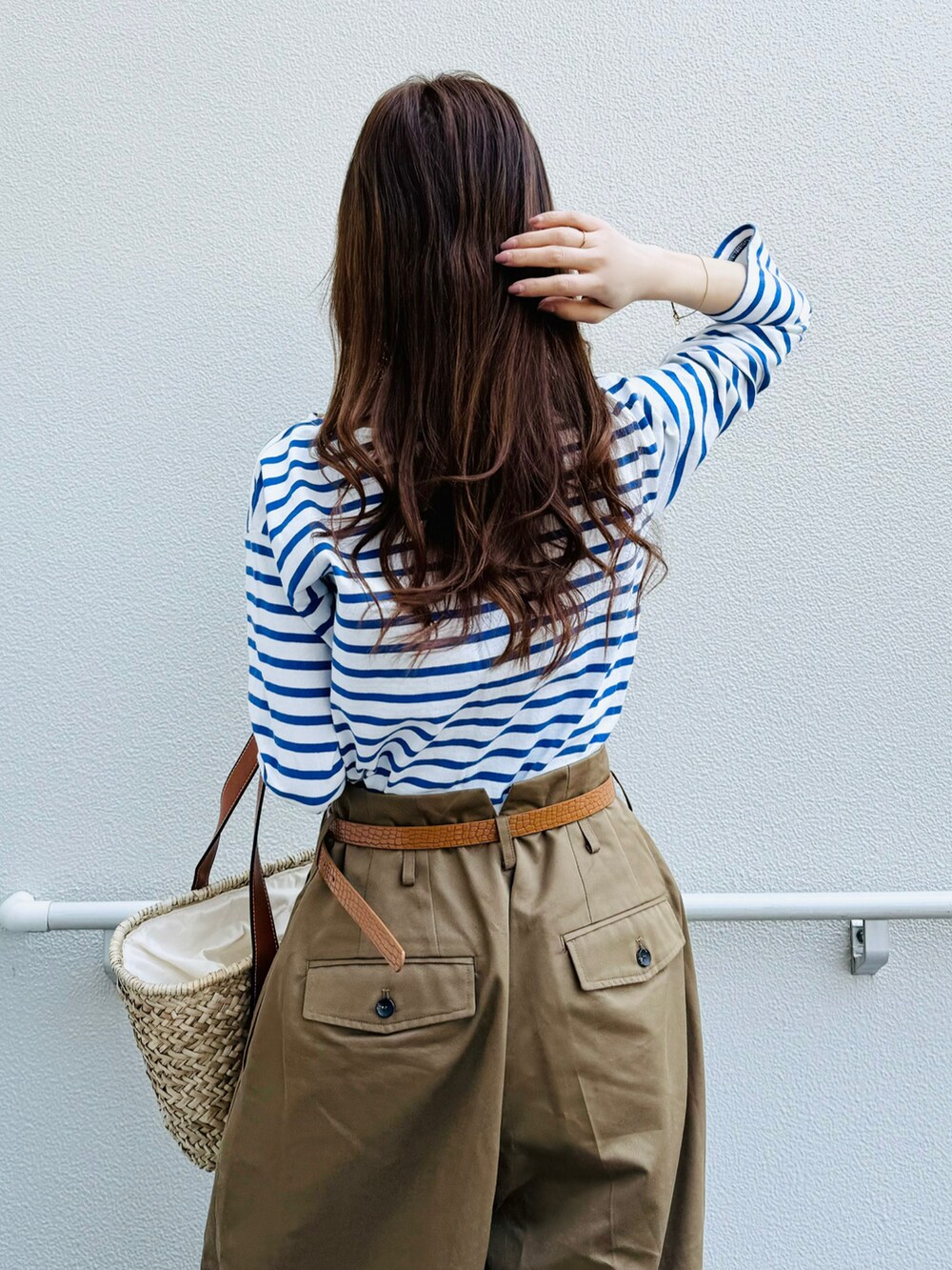 ブルー系のTシャツ/カットソー、ホワイト系のスニーカー、ブラウン系のパンツを着用したレディースの春コーディネートの4枚目の写真