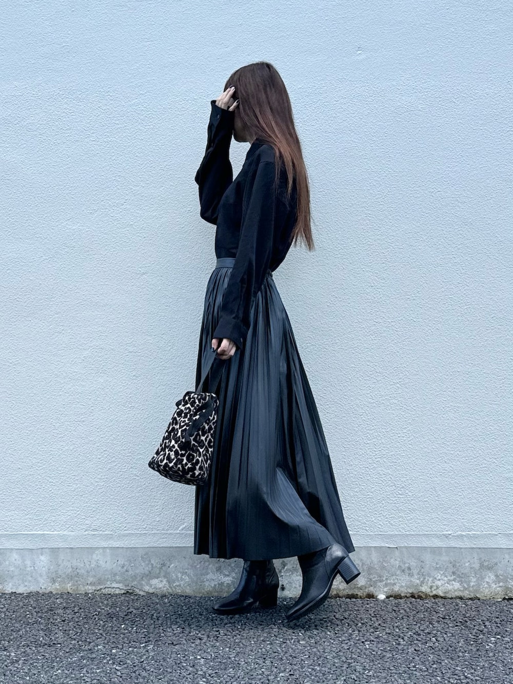 ブラック系のブーツ、ブラウン系のハンドバッグ、ブラック系のシャツ/ブラウスを着用したレディースの秋コーディネートの3枚目の写真