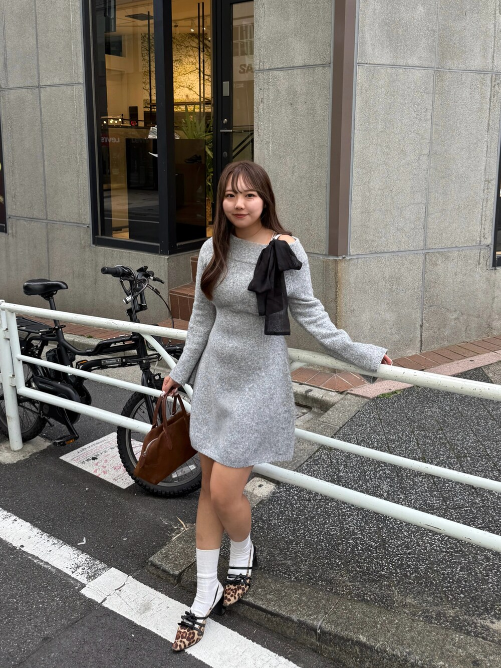 グレー系のワンピースを着用したレディースの秋コーディネートの2枚目の写真