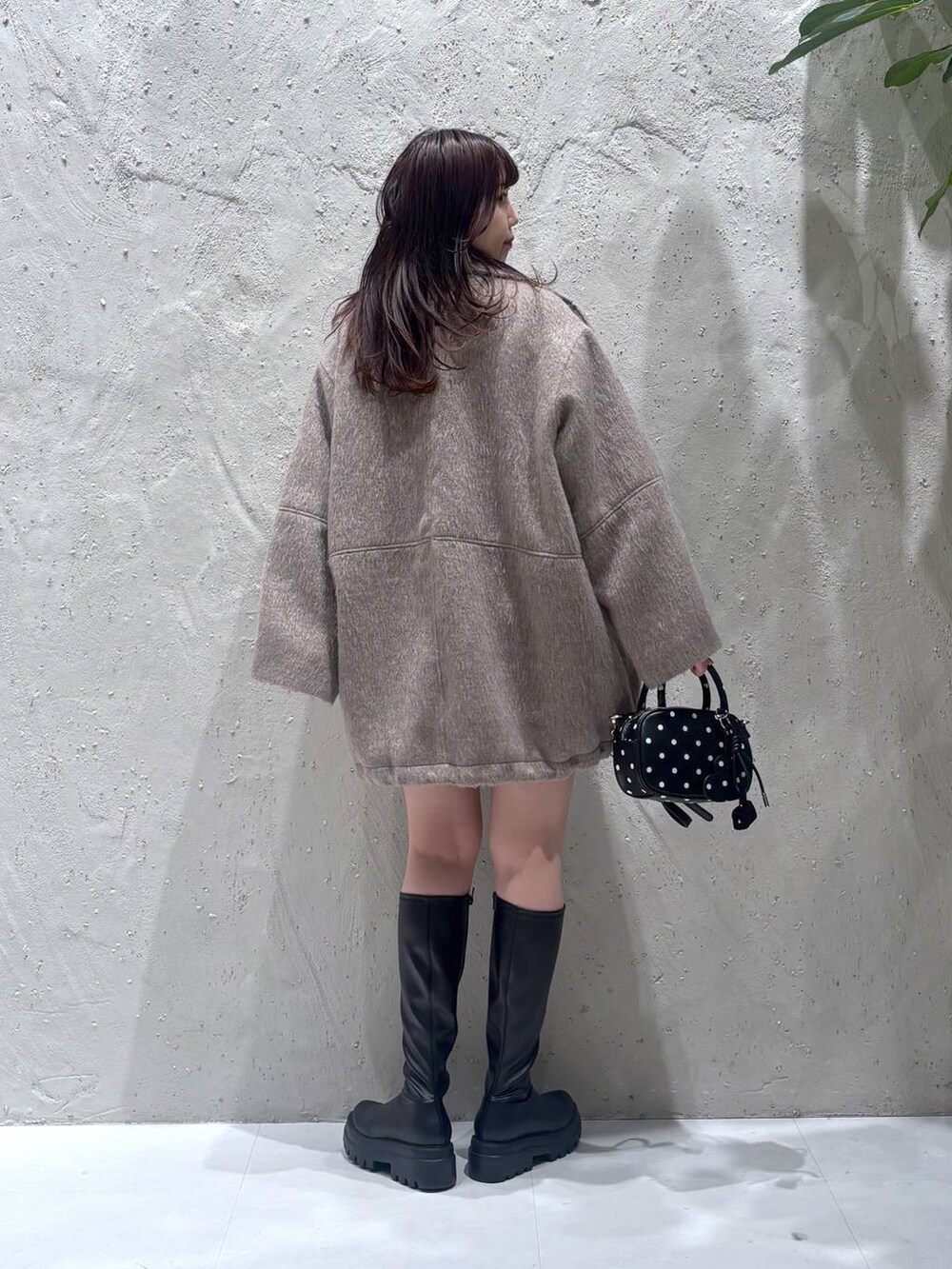 ホワイト系のその他アウター、ブラック系のその他パンツ、ブラック系のブーツを着用したレディースの冬コーディネートの5枚目の写真