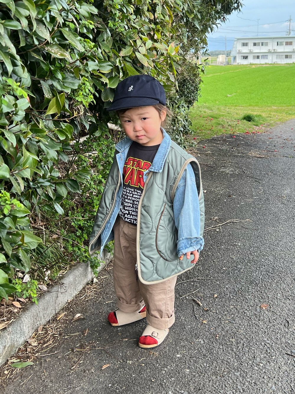 ベージュ系のその他パンツ、ベージュ系のサンダル、ブラック系のTシャツ/カットソーを着用したキッズの春コーディネートの4枚目の写真