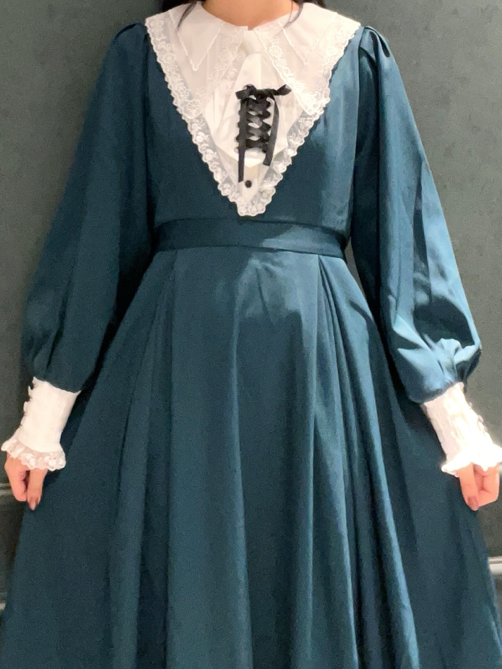 グリーン系のワンピースを着用したレディースの秋コーディネートの5枚目の写真