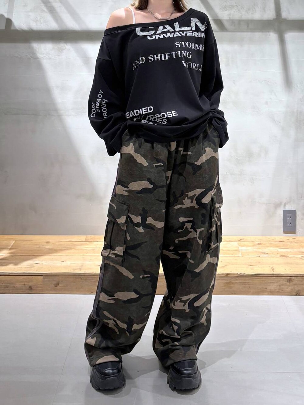 ブラック系のスニーカー、グリーン系のスウェットパンツ、ブラック系のTシャツ/カットソーを着用したレディースの春コーディネートの5枚目の写真