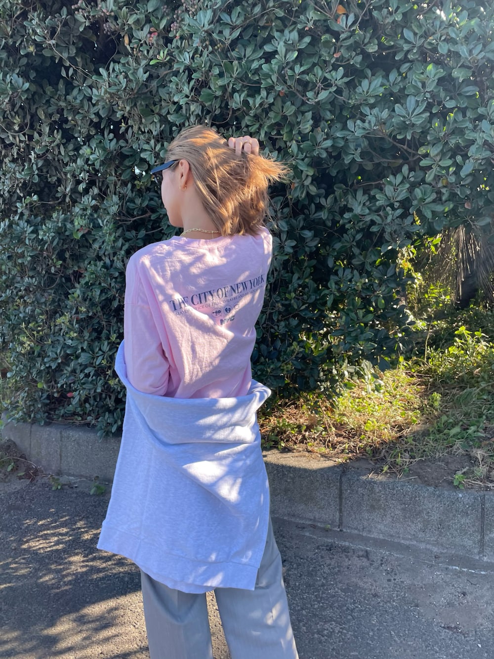 ピンク系のTシャツ/カットソー、グレー系のスウェット、グレー系のスラックスを着用したレディースの秋コーディネートの4枚目の写真