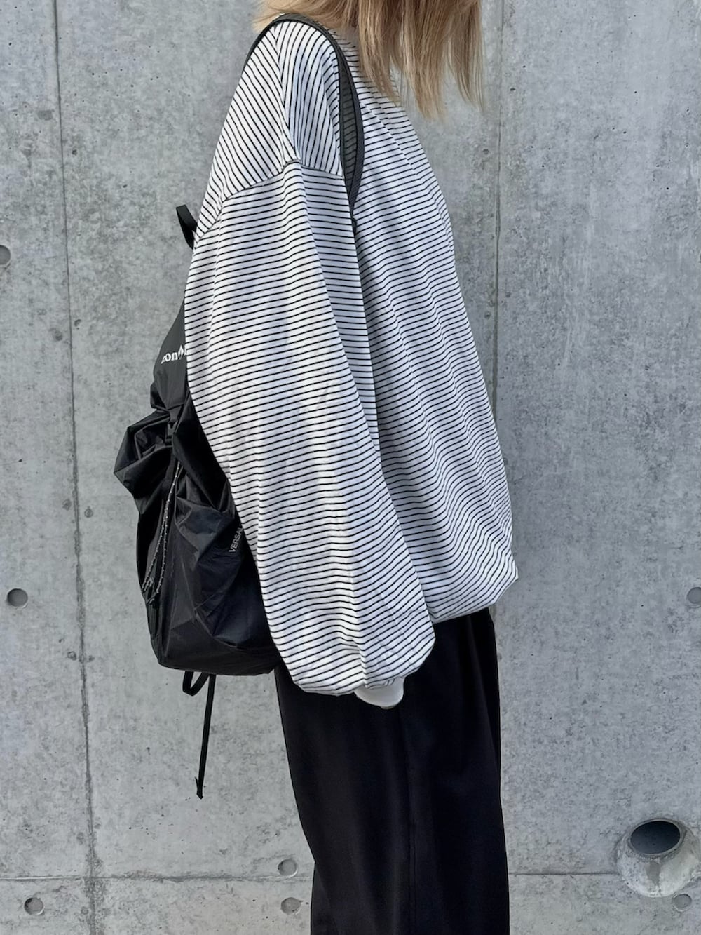 ブラック系のその他パンツ、ホワイト系のスニーカー、ブラック系のバッグを着用したレディースの秋コーディネートの2枚目の写真