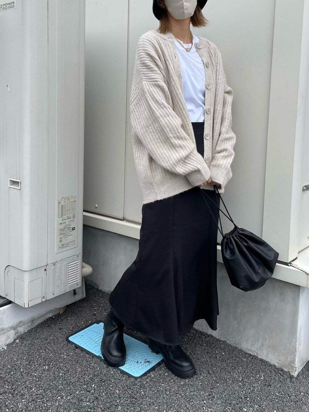 ホワイト系のTシャツ/カットソー、ブラック系のスカート、ブラック系のショルダーバッグを着用したレディースの秋コーディネートの2枚目の写真