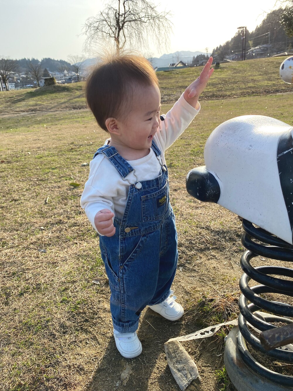 ブルー系のTシャツ/カットソー、ブルー系のデニムパンツ、ブラック系のスニーカーを着用したレディースの春コーディネートの3枚目の写真