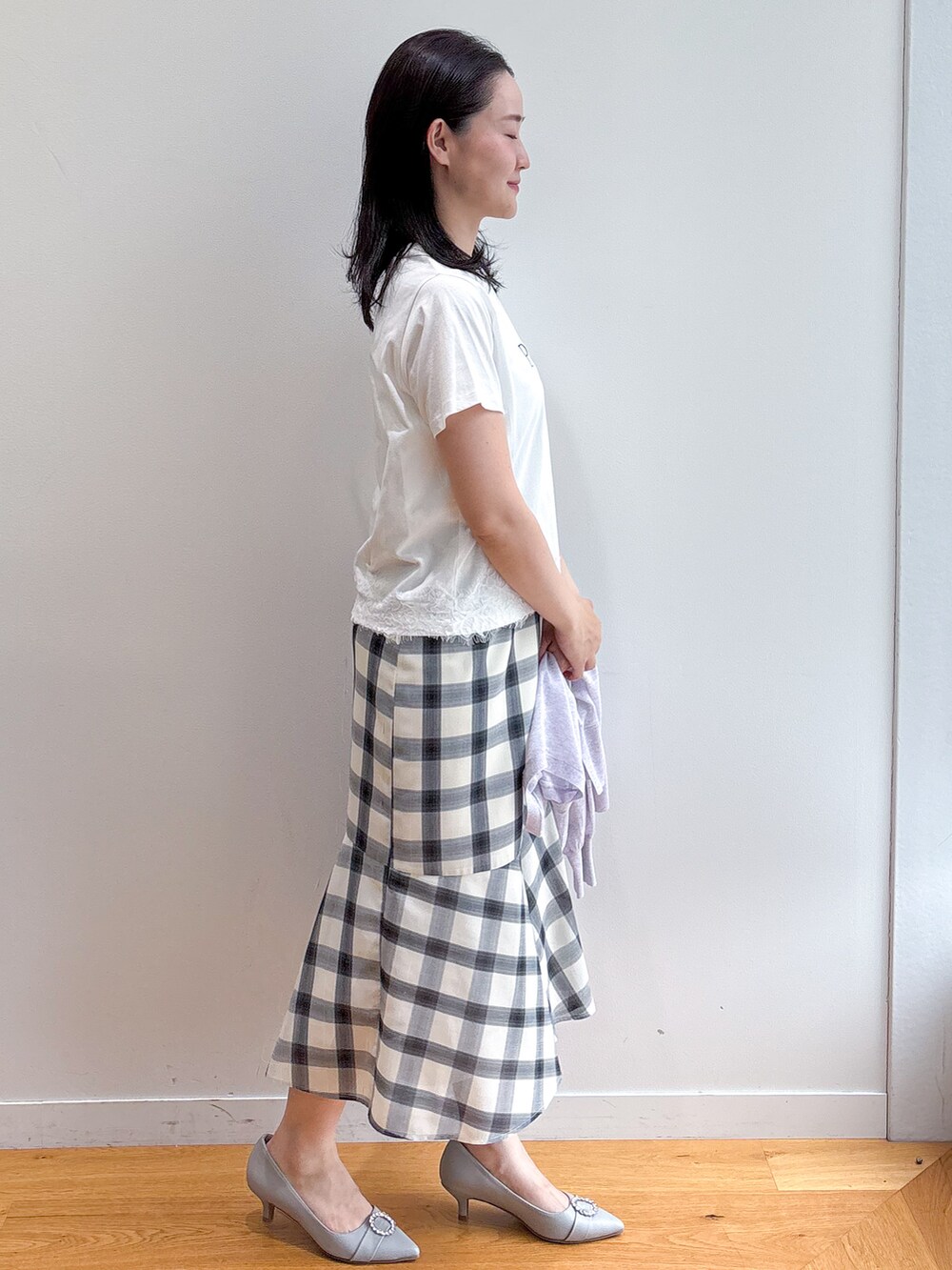 ホワイト系のTシャツ/カットソー、ホワイト系のスカート、グレー系のパンプスを着用したレディースの夏コーディネートの2枚目の写真