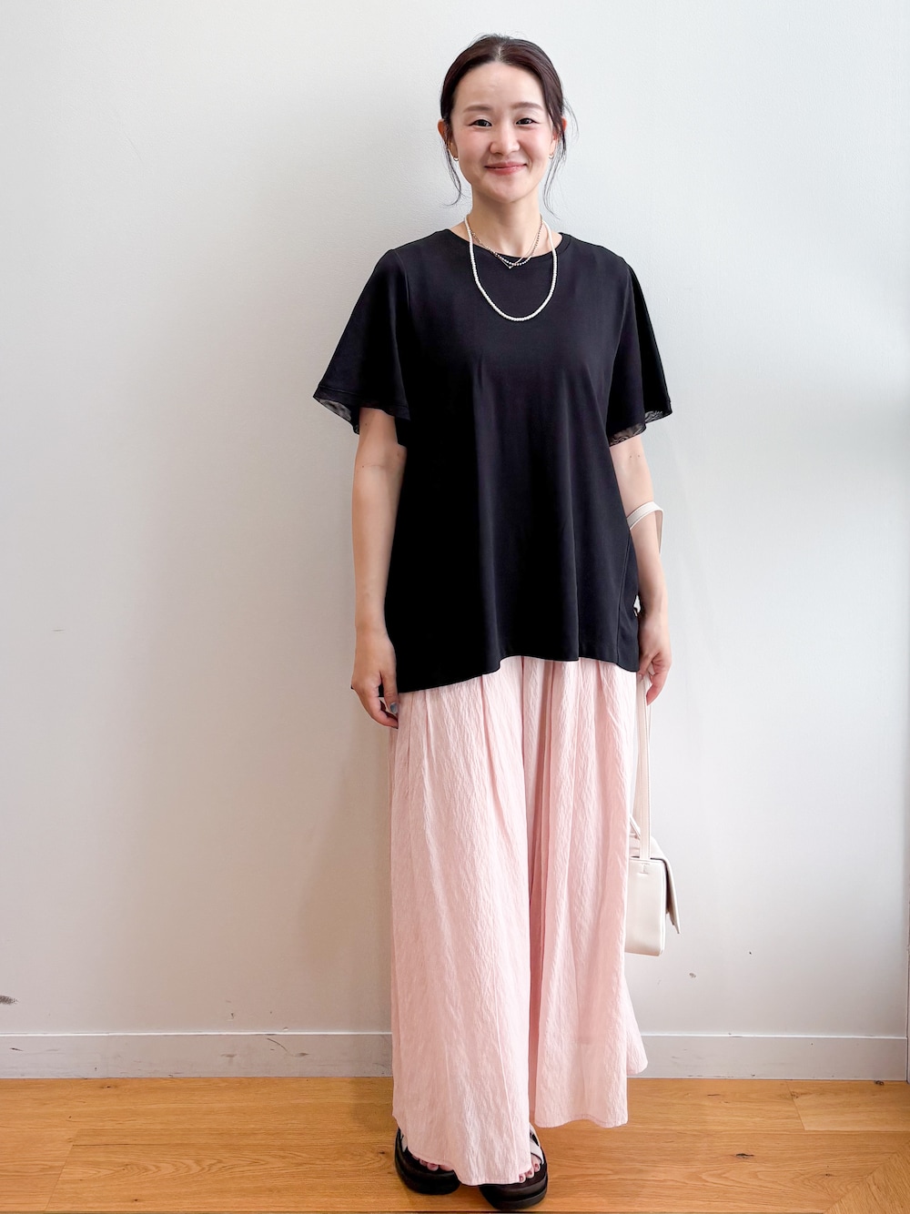 ブラック系のTシャツ/カットソー、ピンク系のその他パンツ、ホワイト系のサンダルを着用したレディースの夏コーディネートの2枚目の写真