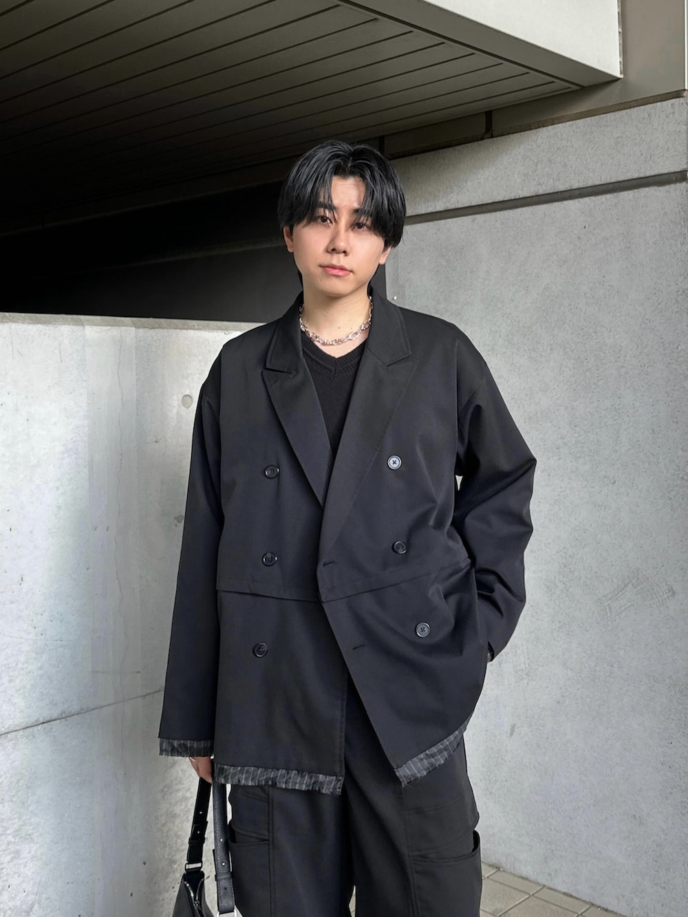 ブラック系のブーツ、ブラック系のテーラードジャケット、ブラック系のスラックスを着用したメンズの冬コーディネートの4枚目の写真