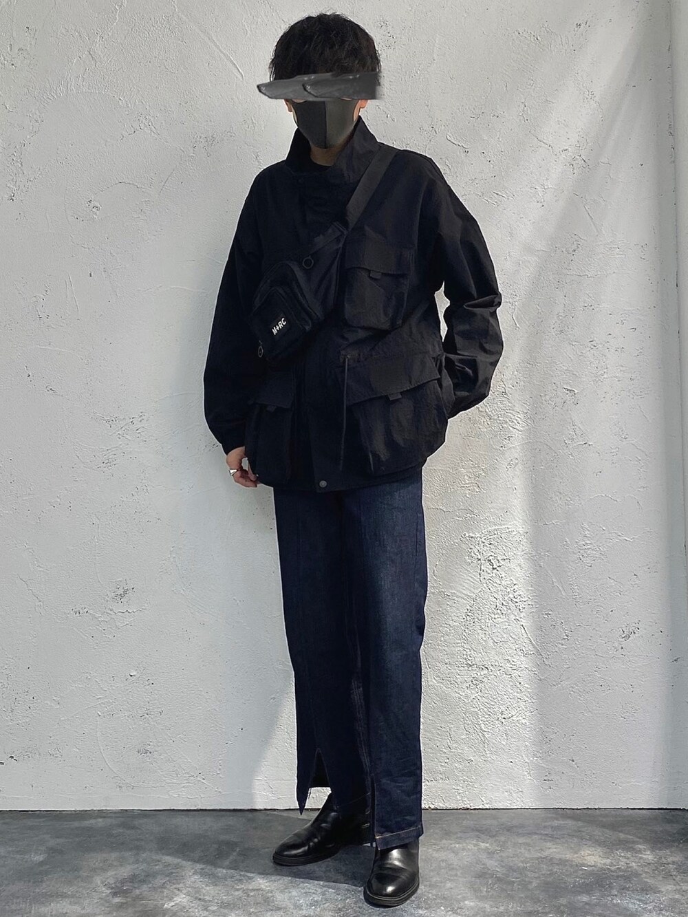 ブラック系のミリタリージャケット、ブルー系のその他パンツ、ブラック系のショルダーバッグを着用したメンズの冬コーディネートの2枚目の写真