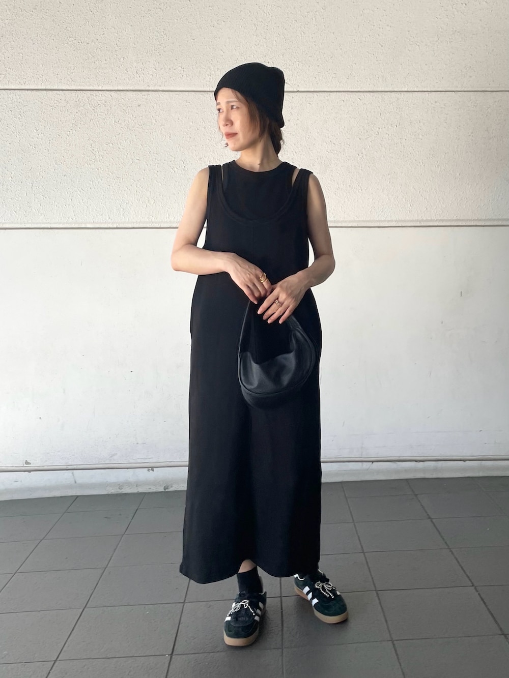 ブラック系のワンピース、ブラック系のスニーカー、ブラック系のシューズアクセサリーを着用したレディースの夏コーディネートの3枚目の写真