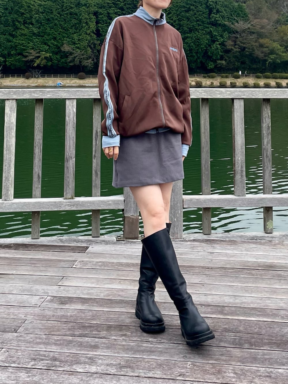 ブラウン系のジャージ、ホワイト系のTシャツ/カットソー、ブラック系のブーツを着用したレディースの秋コーディネートの3枚目の写真