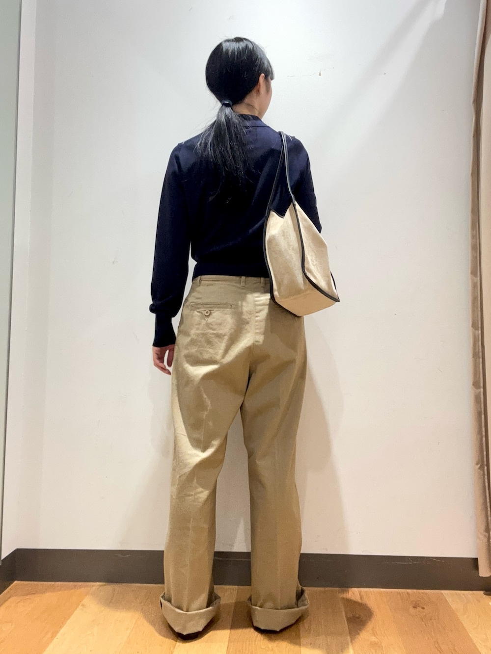 ベージュ系のその他パンツ、ブルー系のカーディガン/ボレロ、ベージュ系のトートバッグを着用したレディースの秋コーディネートの4枚目の写真