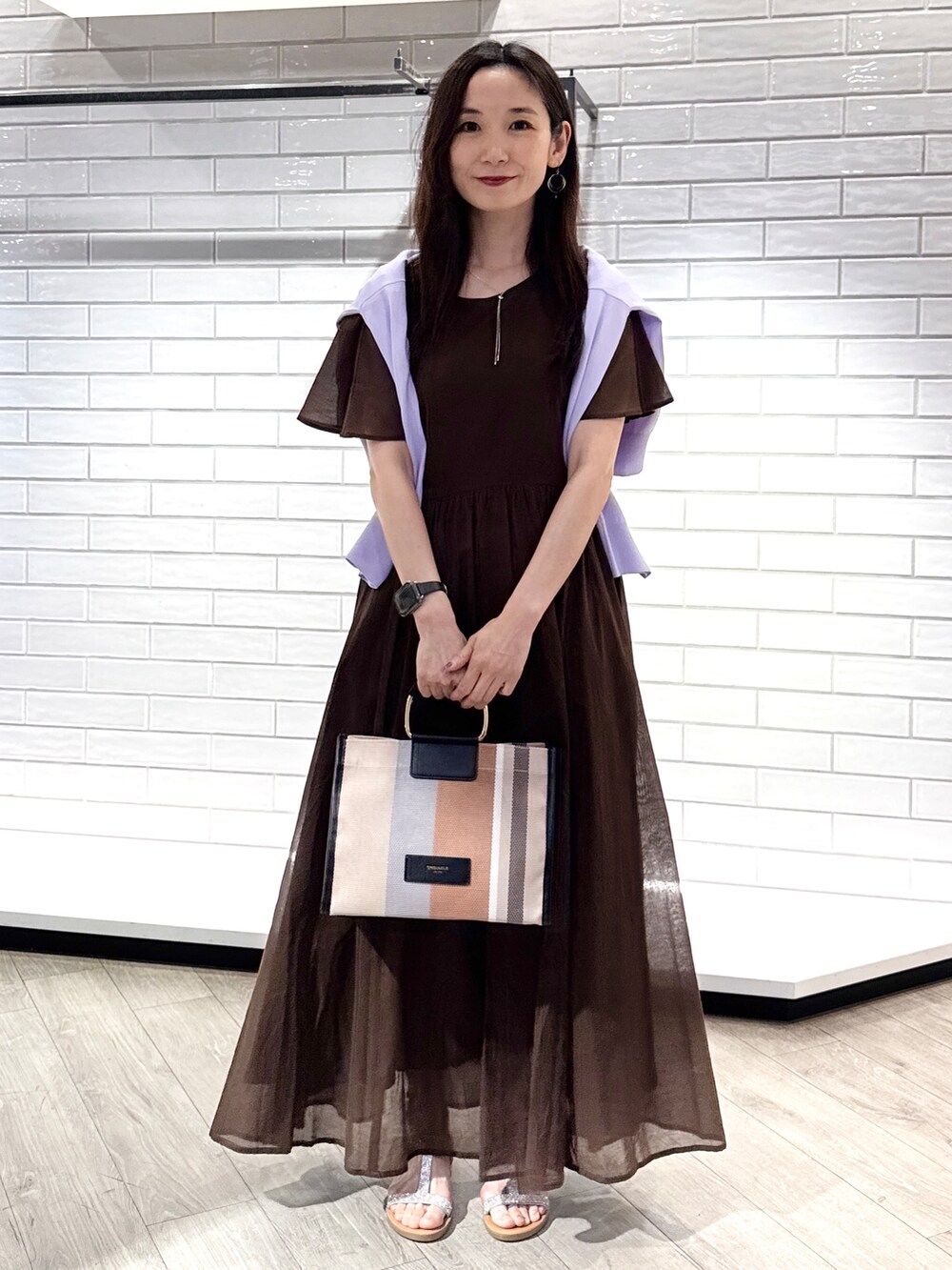 パープル系のカーディガン/ボレロ、ブラウン系のワンピース、ブラック系のトートバッグを着用したレディースの夏コーディネートの7枚目の写真